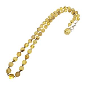 Amber Sterling Silver Beaded Necklace. Round-shape amber stones set on an elastic cord finished with a .925 sterling silver clasp. 16.5" long. Genuine Baltic amber beaded necklace jewelry. 